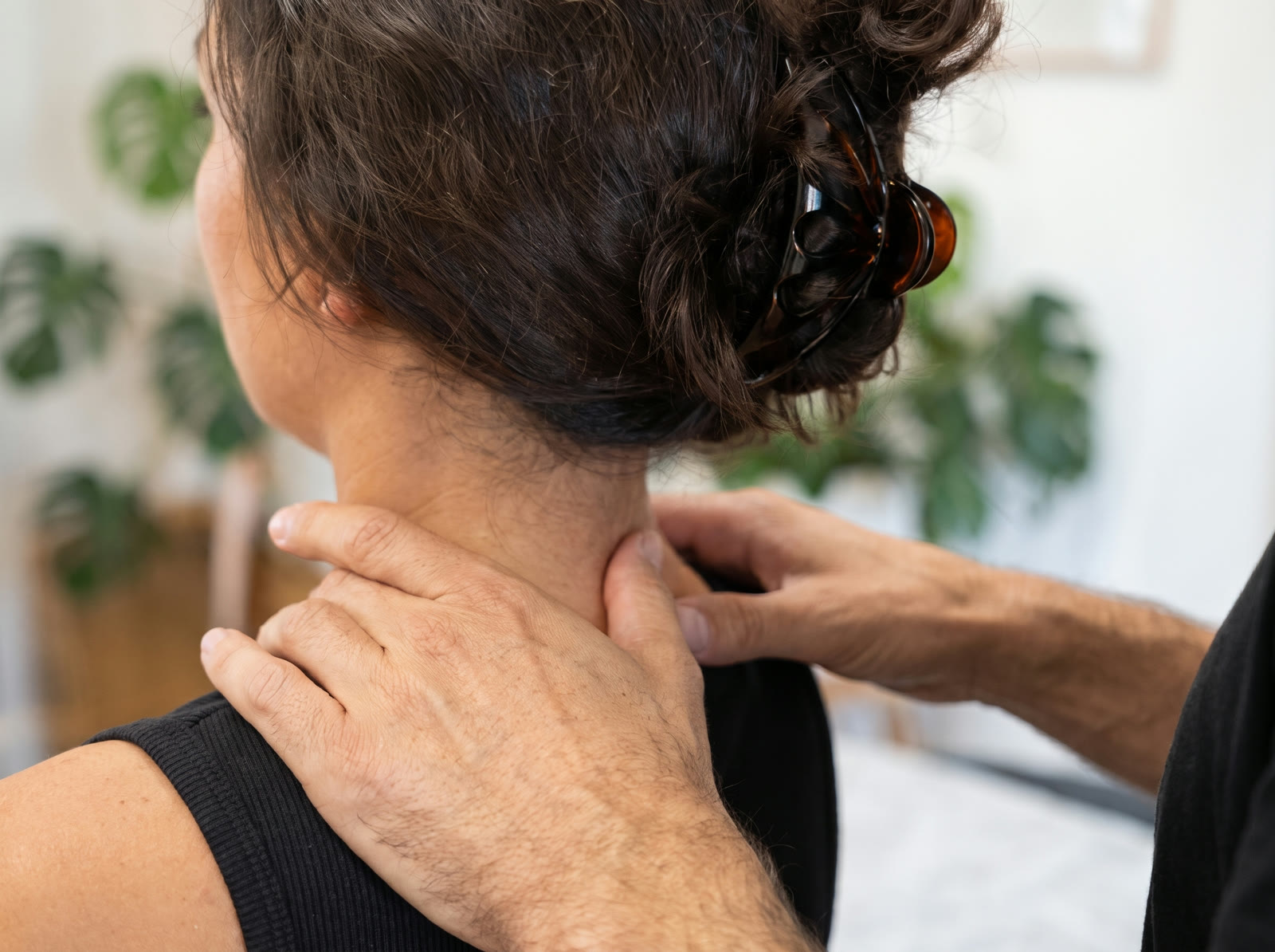 Osteopath treating a client's neck